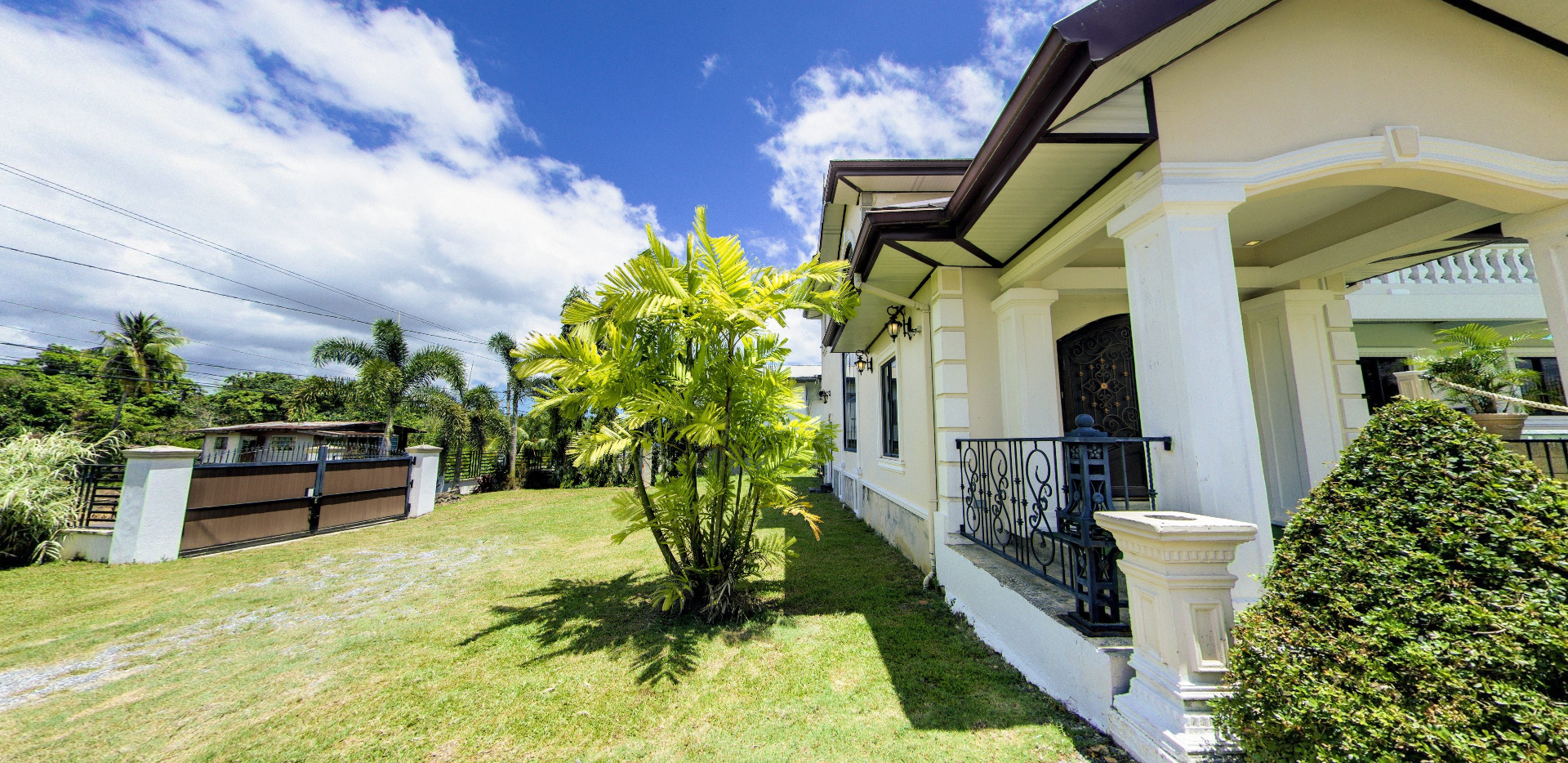Side view of the villa's covered porch and lawn