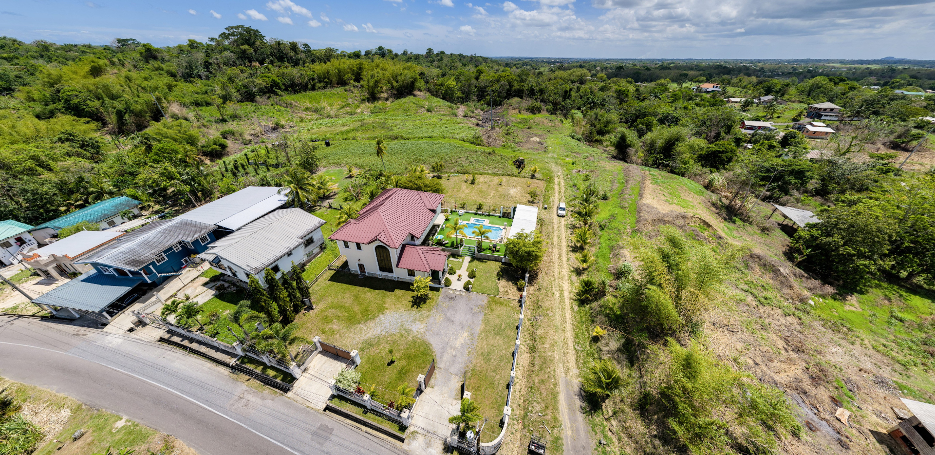Wide aerial view of the property and surrounding hills