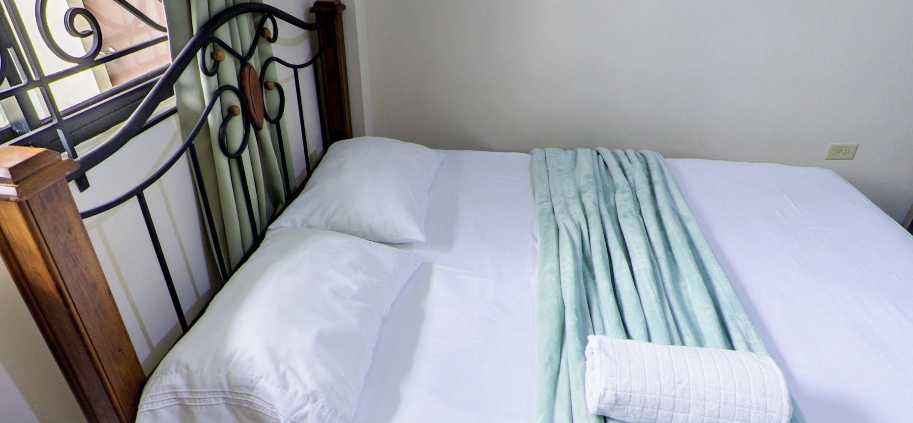 Wrought-iron headboard and fresh linens