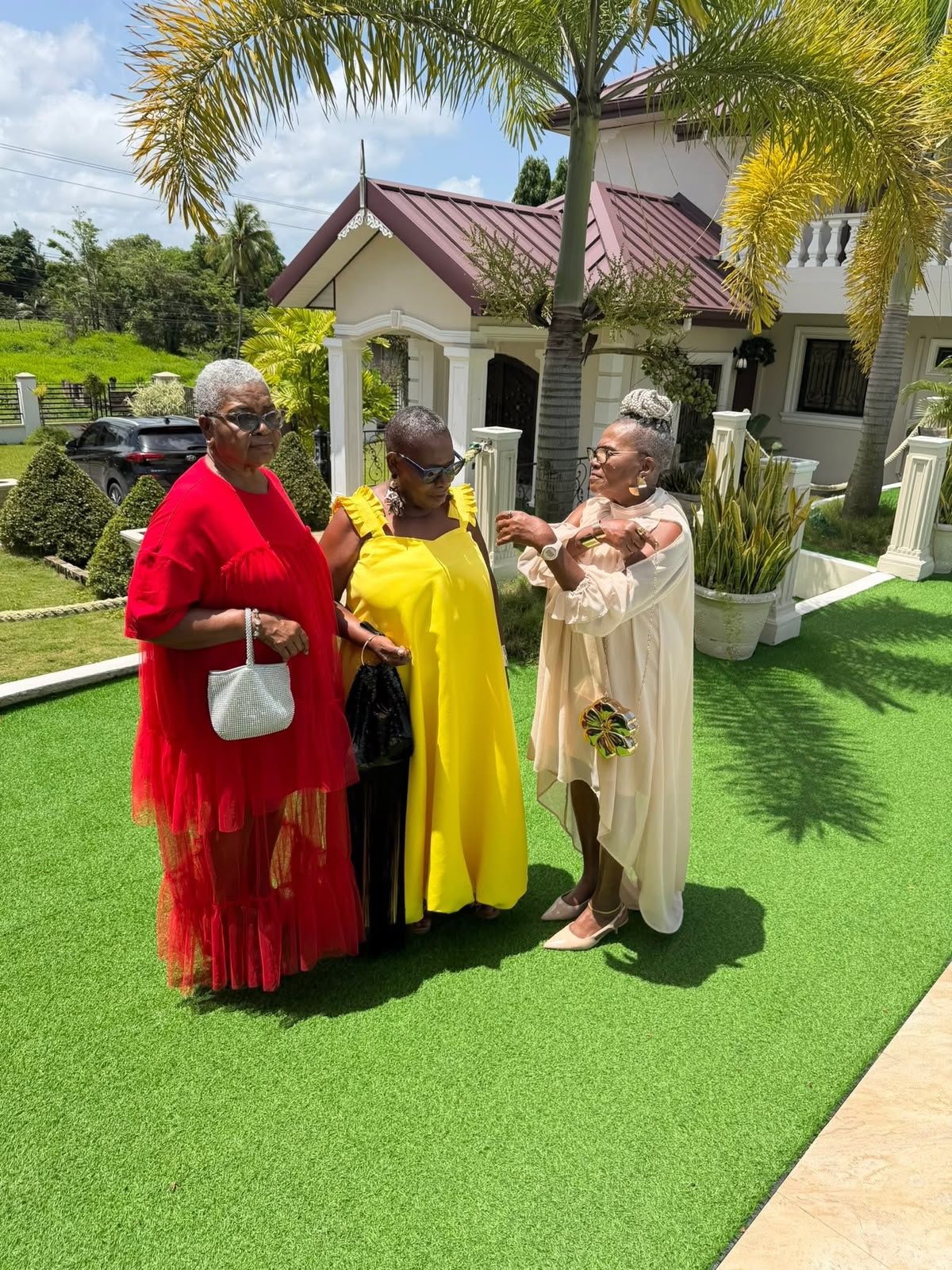 Guests gathered on the manicured front lawn at Vintage Oaks Hideaway, Moruga