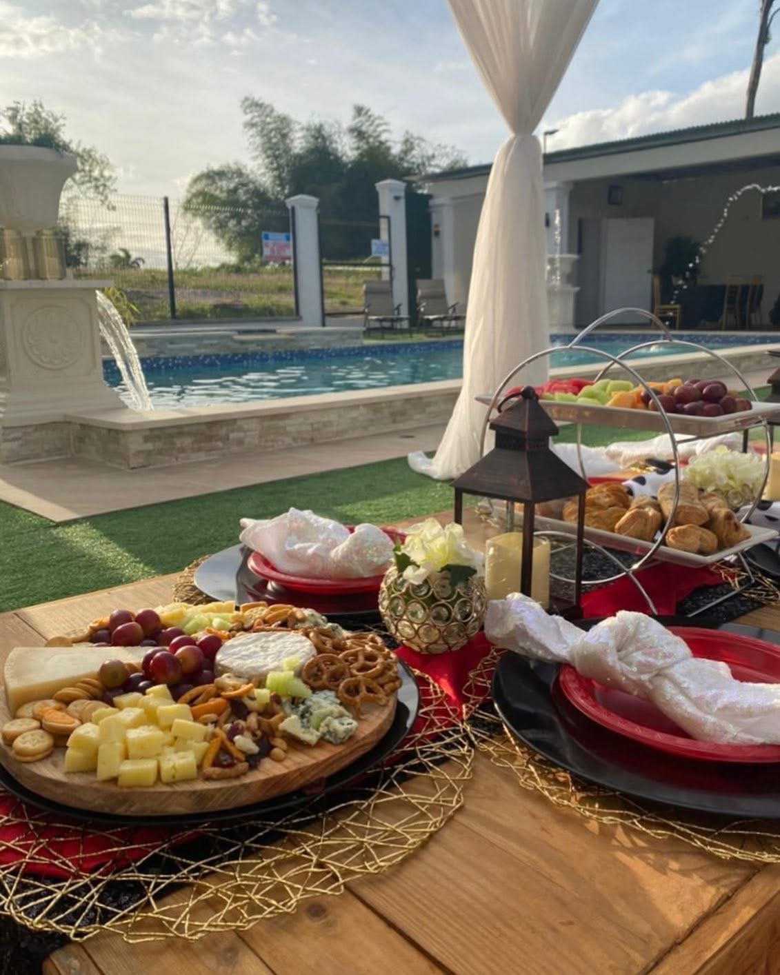 Grazing board and cabana drapes beside the pool at Vintage Oaks Hideaway