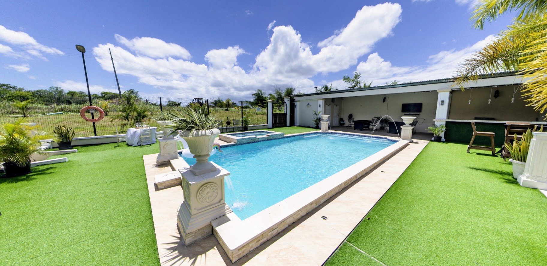 Pool with cabana and open grounds beyond