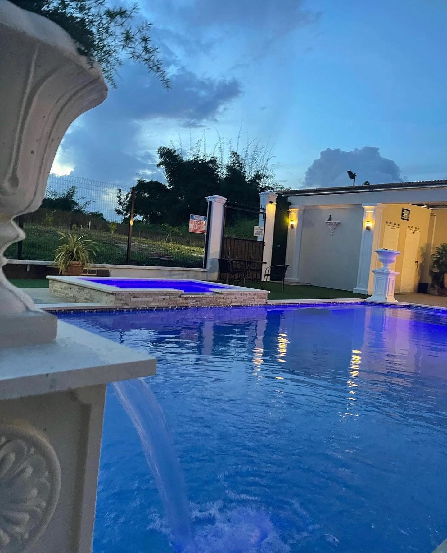 Pool lit blue at dusk