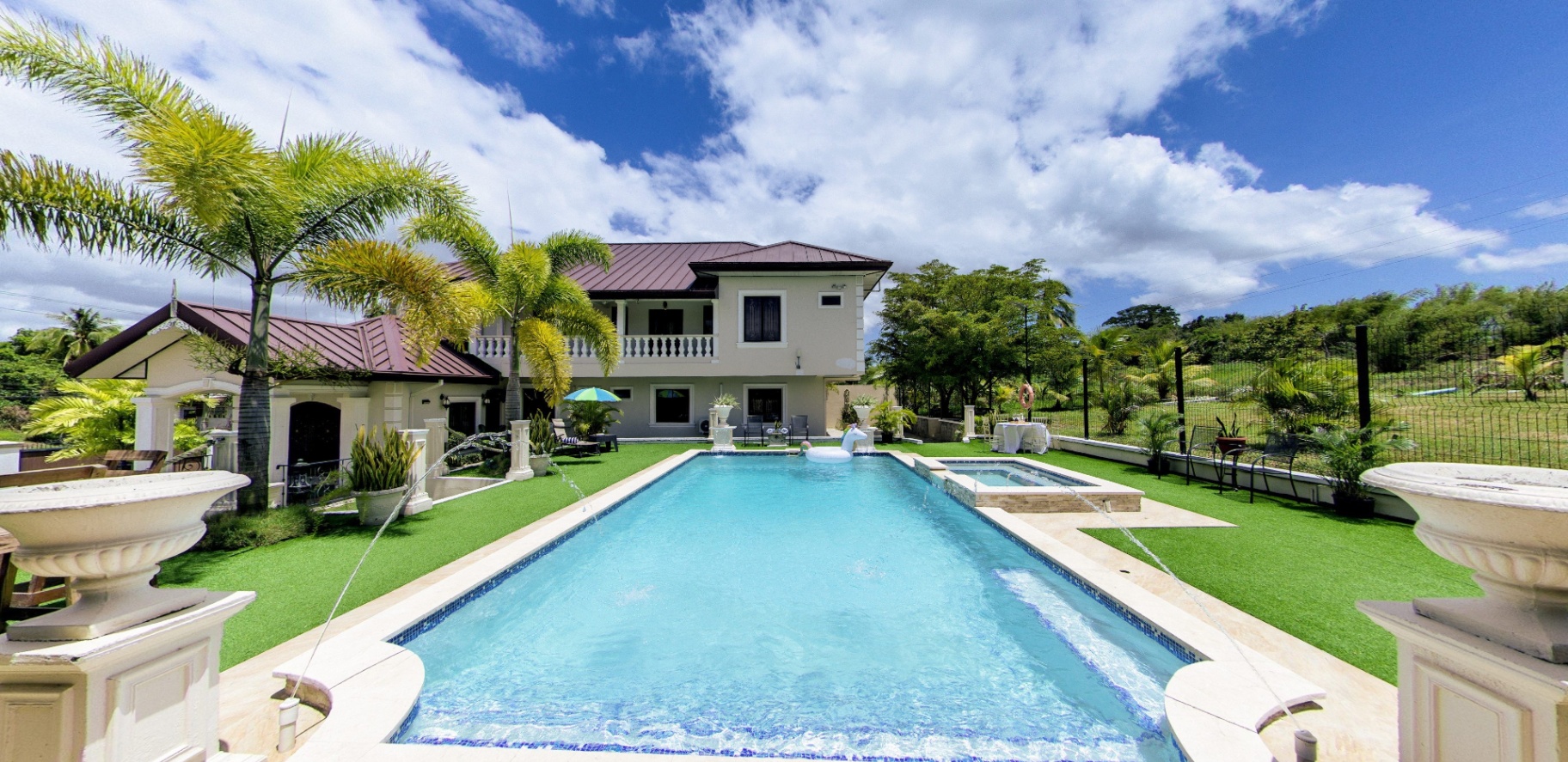 Pool view toward the main villa with fountains