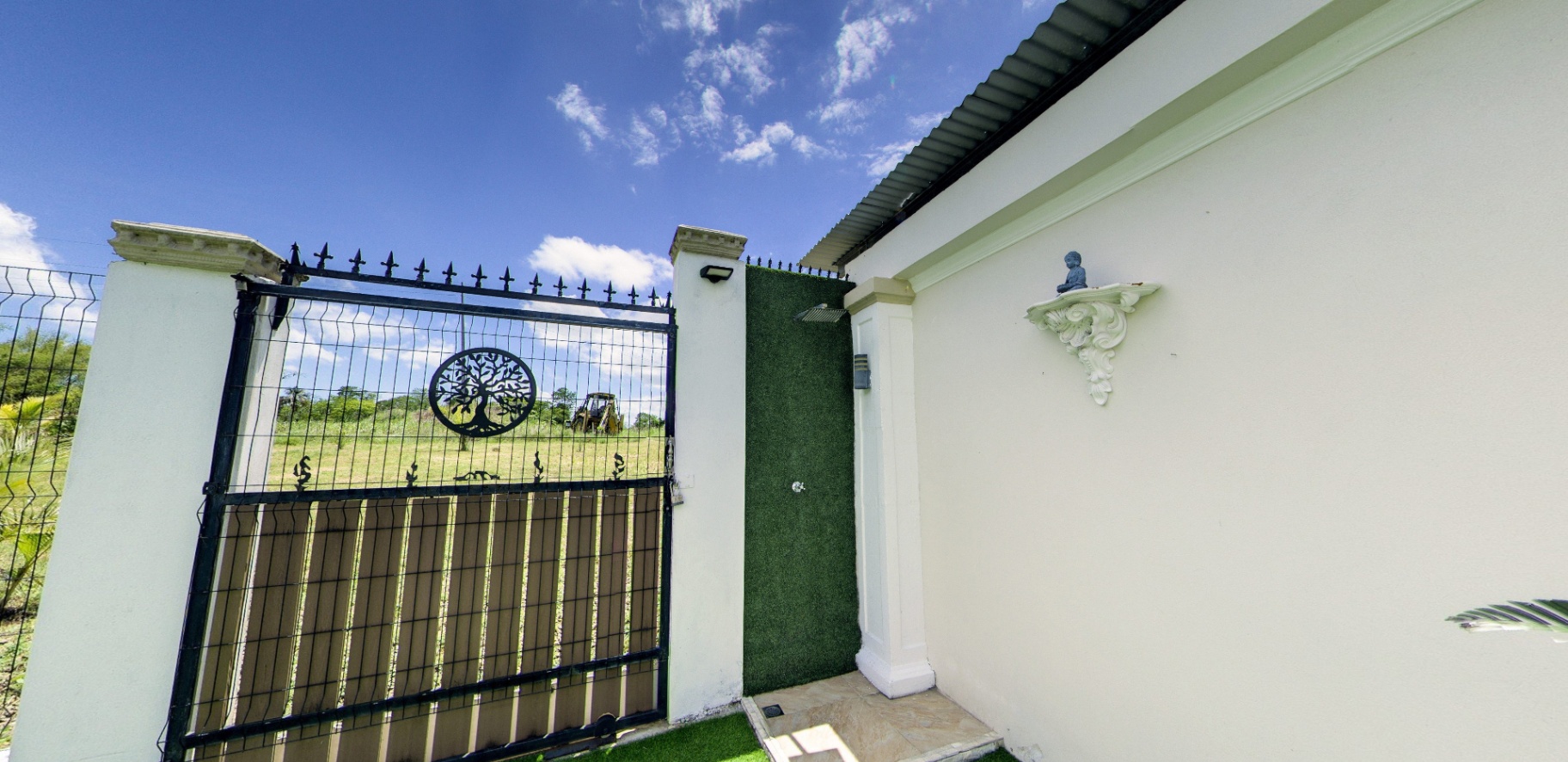 Outdoor rain-shower and tree-of-life gate
