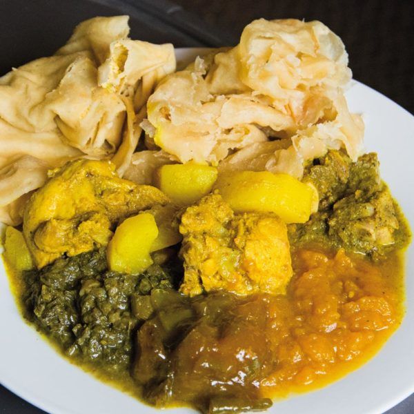 Buss-up-shut paratha roti with curried chicken, potato, bhaji and pumpkin
