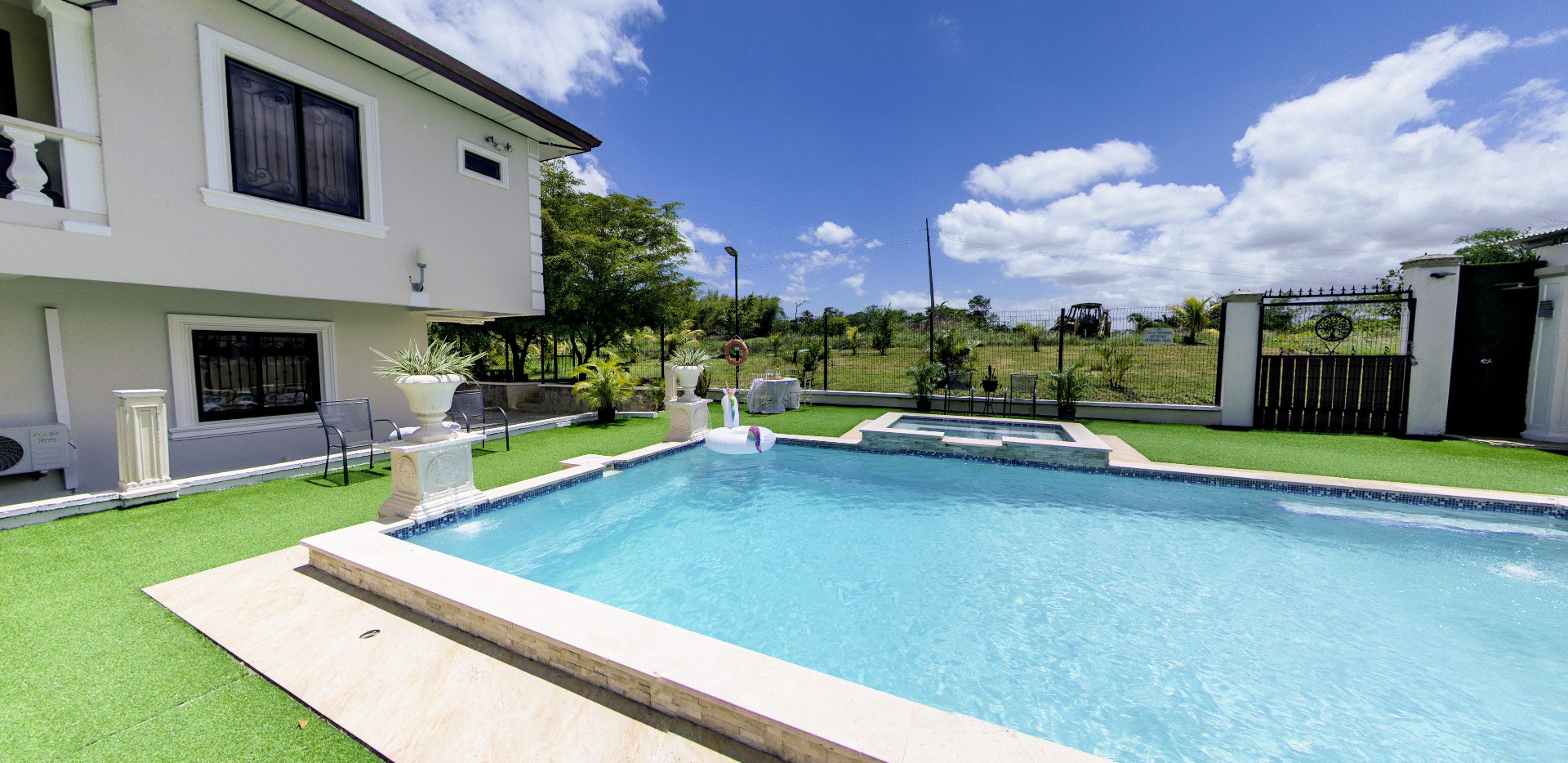 Poolside view of the villa with open countryside beyond