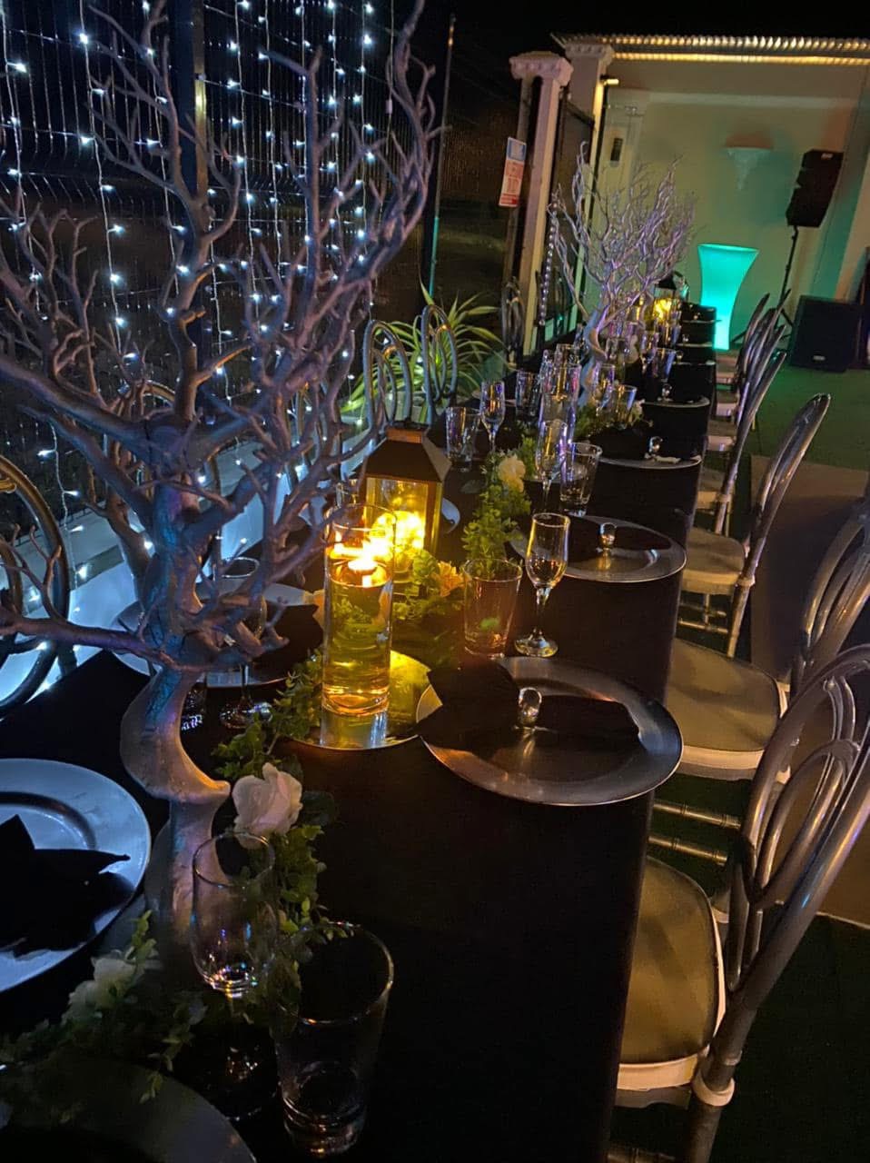 Long table set with lanterns and fairy lights for an evening function at the Moruga venue