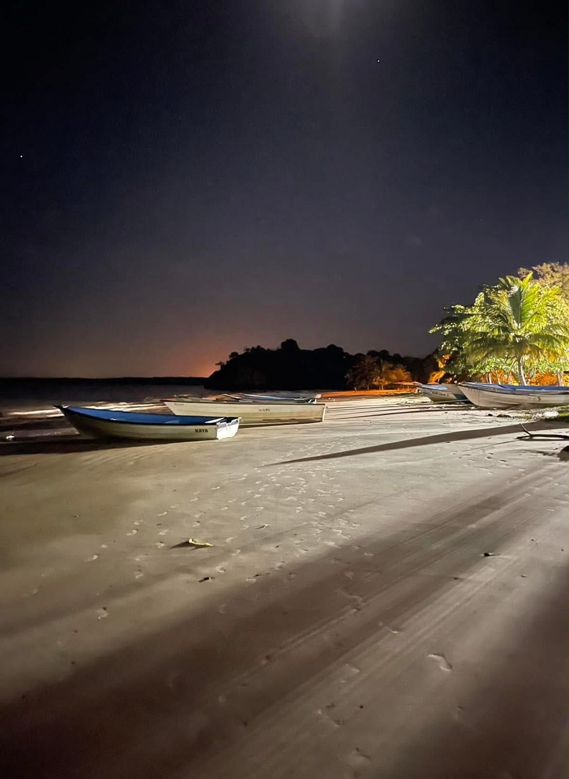 Boats resting on Moruga beach under a starlit sky