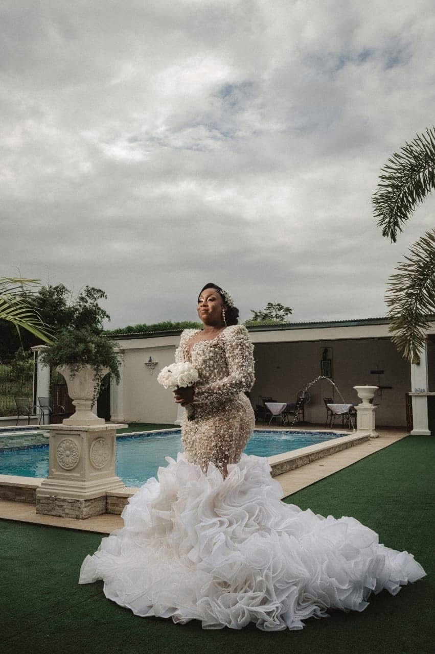 Bride in a beaded gown beside the pool at a Vintage Oaks Hideaway wedding in Moruga