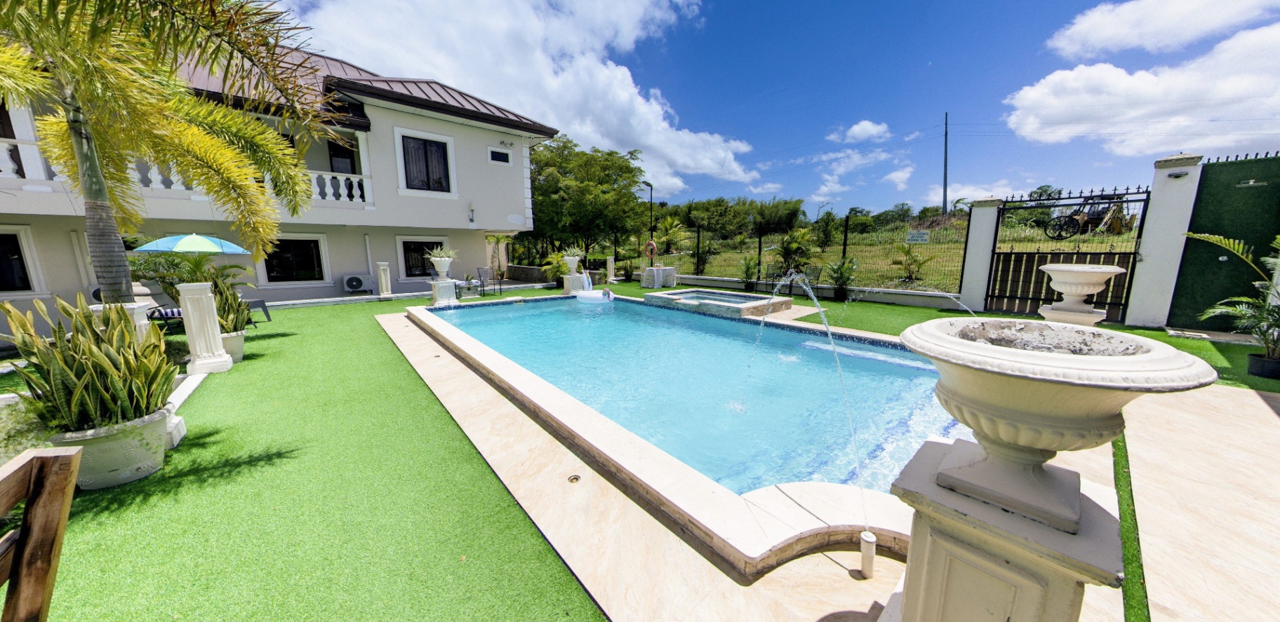 Poolside with fountain urns and lounge deck